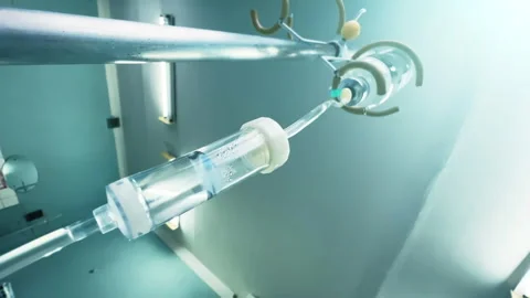 Drip chamber with a dropper bottle with the IV on a stand. Intravenous injection Stock Footage 258182937