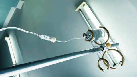 Drip chamber of a IV with dropper bottle on a stand. Intravenous injections Stock Footage 258987858