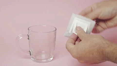 Drip coffee bag, brews coffee in a glass mug on a pink background 스톡 동영상 218242697