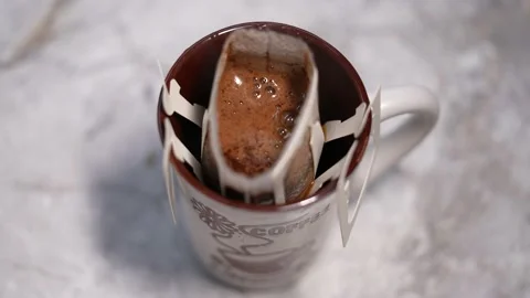 Drip coffee bag, brews coffee in a glass mug. Stock Footage 238700304