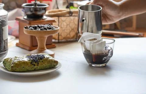 Drip coffee in a bag, drip in a clear coffee mug. Stock Photos