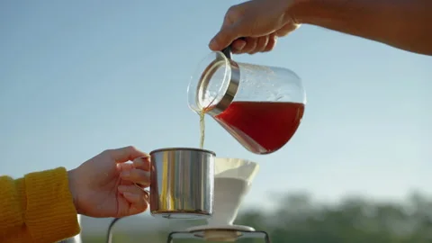 Drip coffee brewed when camping outdoors, coffee poured into a filter cup Stock-Footage 226815603
