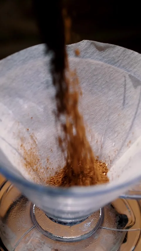 Drip coffee brewing. close-up. barista pours, puts freshly ground coffee beans Video stock 323514388