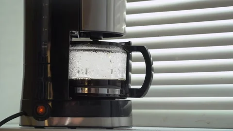 Drip coffee maker brews freshly brewed coffee. Close up coffee dripping into pot Stock Footage 256285333
