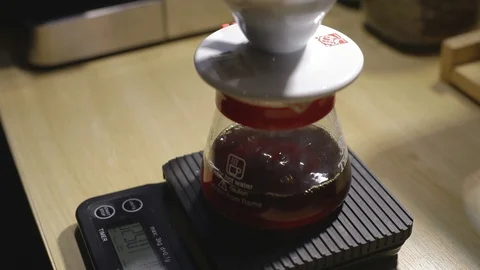 Drip coffee maker. Dripping coffee on scaling device while brewing Video stock 95532728