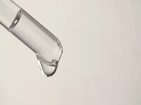 Drip drop from pipette 4k slow motion close up video white background Stock Footage 83931984