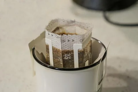 Drip filter coffee bag in ceramic cup close-up indoors daytime Stock Photos