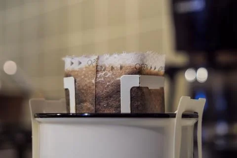 Drip filter coffee bag in ceramic cup, extreme close-up view Foto stock