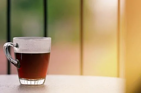 Drip or brewed coffee on the table with sun light, blurred background Stock Photos