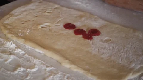 Drip the tomato paste onto the dough. Stock Footage 154507436