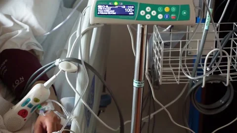 Premium Photo  Iv drip chamber and iv bag of solution with patient on bed  blurd background in patient room hospital