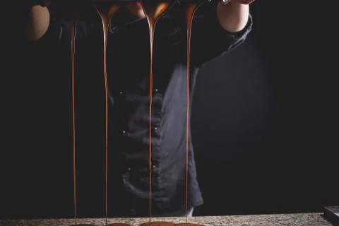 Dripping chocolate for making Easter eggs Stock Photos