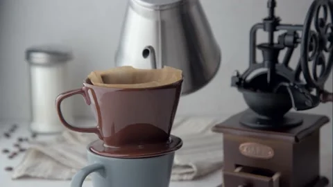 Dripping coffee image with mug , paper filter and kettle Stock Footage 143124016