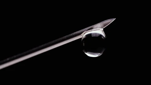 Dripping drops on a sharp needle close up on a black background Stock Footage 150391201