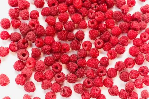 Dripping frash raspberry on the white background. Stock Photos