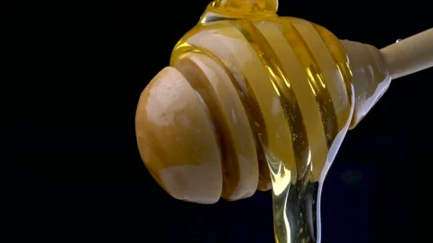 Dripping fresh honey on a black background Stock Footage 97055836
