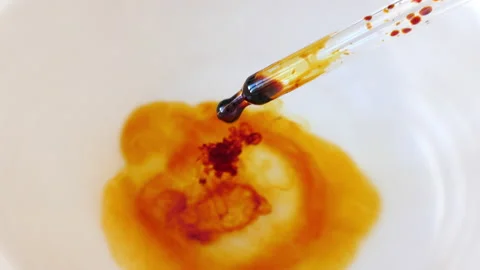 Dripping Iodine into water. Lugol's solution. Stock Footage 157057448