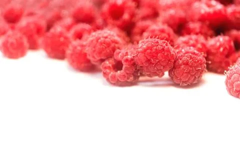 Dripping raspberry on white background. Stock Photos