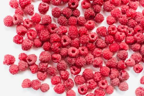 Dripping raspberry on white background. Stock Photos