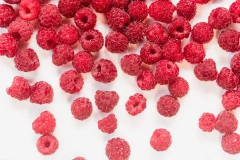 Dripping raspberry on white background. Stock Photos