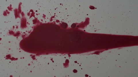 Dripping of red paint on a white surface Video stock 253225325
