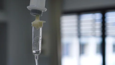 Dripping of set iv fluid intravenous drop saline solution in hospital room. Stock Footage