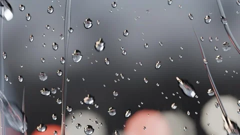 Dripping water droplets forming thin streaks on window at night, gravity pulling Vídeo Stock 341865095