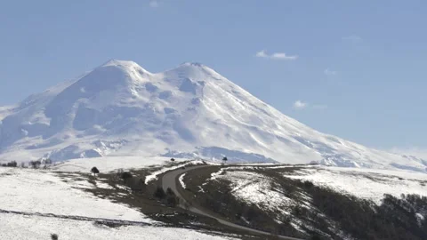 Drive a black car through the mountains. Snow caps of the mountains.  Stock Footage 292880484