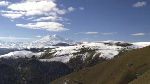 Drive a black car through the mountains. Snow caps of the mountains.  Stock Footage 292880494