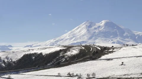 Drive a black car through the mountains. Snow caps of the mountains. Stock Footage 292880502