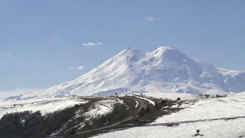 Drive a black car through the mountains. Snow caps of the mountains. Stock Footage 292880541