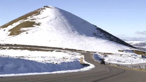 Drive a black car through the mountains. Snow caps of the mountains.  Stock Footage 292880696