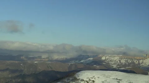 Drive a black car through the mountains. Snow caps of the mountains.  Stock Footage 292880824