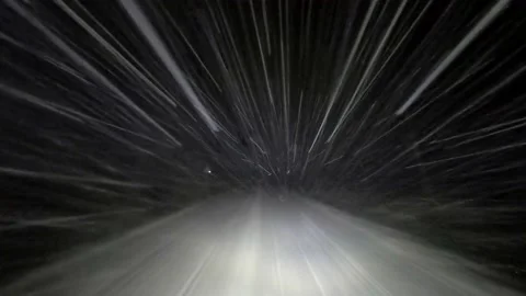 Drive by car at night on a winter forest road in snowfall Video stock 145350404