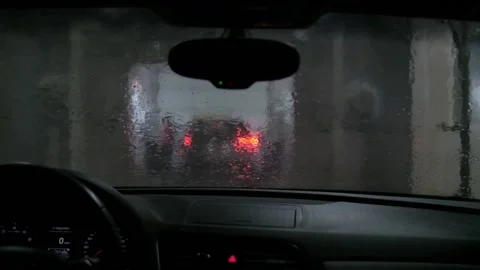 Drive a car outside in a heavy rain storm Stock Footage