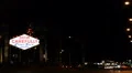 Drive Carefully Come Back Soon Las Vegas Neon Sign Cars Passing Night Traffic HD Footage