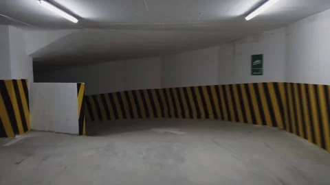 Drive in dark dramatic underground parking lot in modern building, pov Stock Footage 250006054