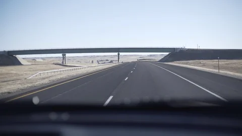 Drive Down I-90 Wyoming Shaky Handheld Shot Under Overpass POV Front Window Stock Footage 88016293