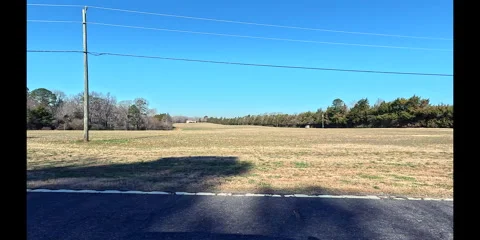 Drive By Open Field With Power Lines Stock Footage 303108084
