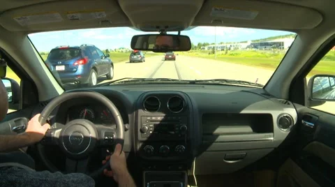 Drive plate, back seat POV divided highway enter city, traffic Stock Footage