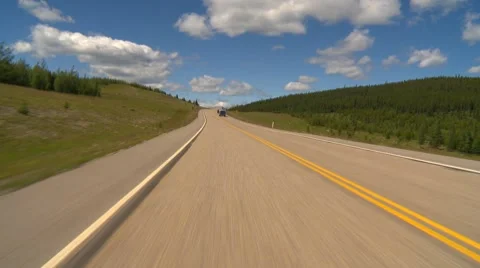 Drive plate, forested hilly rural light traffic in distance, mostly sunny, #7 Stock Footage
