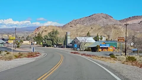Drive Plate-Forward view-curving street in Beatty, Nevada Stock Footage 265805830