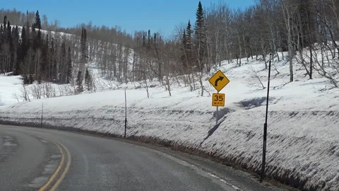 Drive Plate- Forward-Weathered two lane-Snowy forest-Clear bright day Stock Footage 243847408