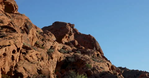 Drive Plate-Looking up passing close by massive rugged red rock formation Stock Footage 237765474