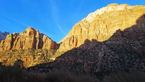 Drive Plate-Passing massive sunlit cliffs Stock Footage 263614189