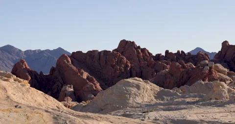 Drive Plate-Passing rugged red rock formation-background mountains Stock Footage 237765639