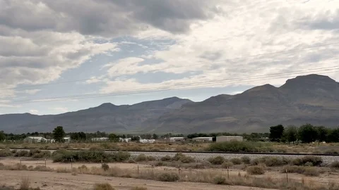 Drive Plate-POV-Side View-Passing desert outskirts Alamagordo NM Mountains Stock Footage 77654070
