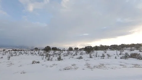 Drive Plate-POV-Side view passing snowy sage and juniper covered hills Stock Footage 103234740
