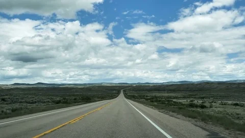 Drive Plate-POV-View forward straight away low hills cloudy sky western Colorado Stock Footage 76506970