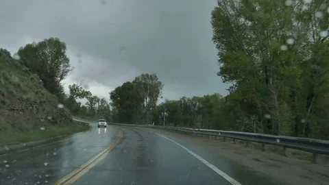 Drive Plate-POV-View forward raining wipers wet 2-lane road Stock Footage 76547385